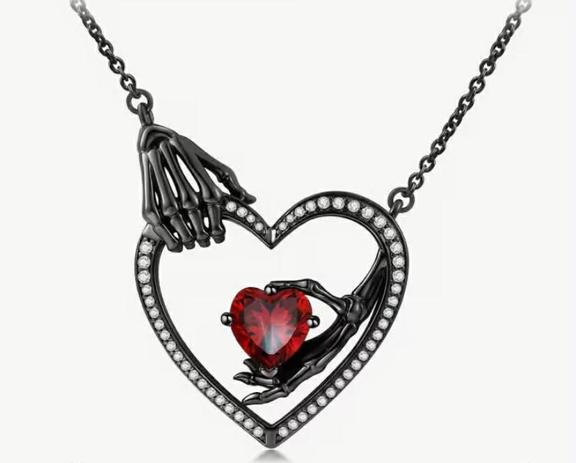 A Dark-Themed Women'S Fashion Necklace Featuring a Gothic Skull Hand Bone Pendant, a Hollow Heart