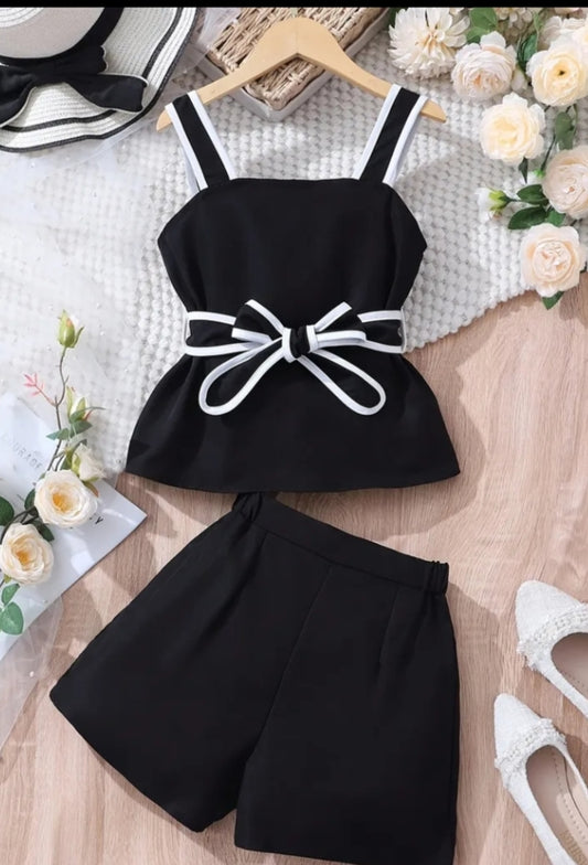 A Set of Two Pieces for Girls Consisting of a Black Tank Top with White Straps And a Belt Design